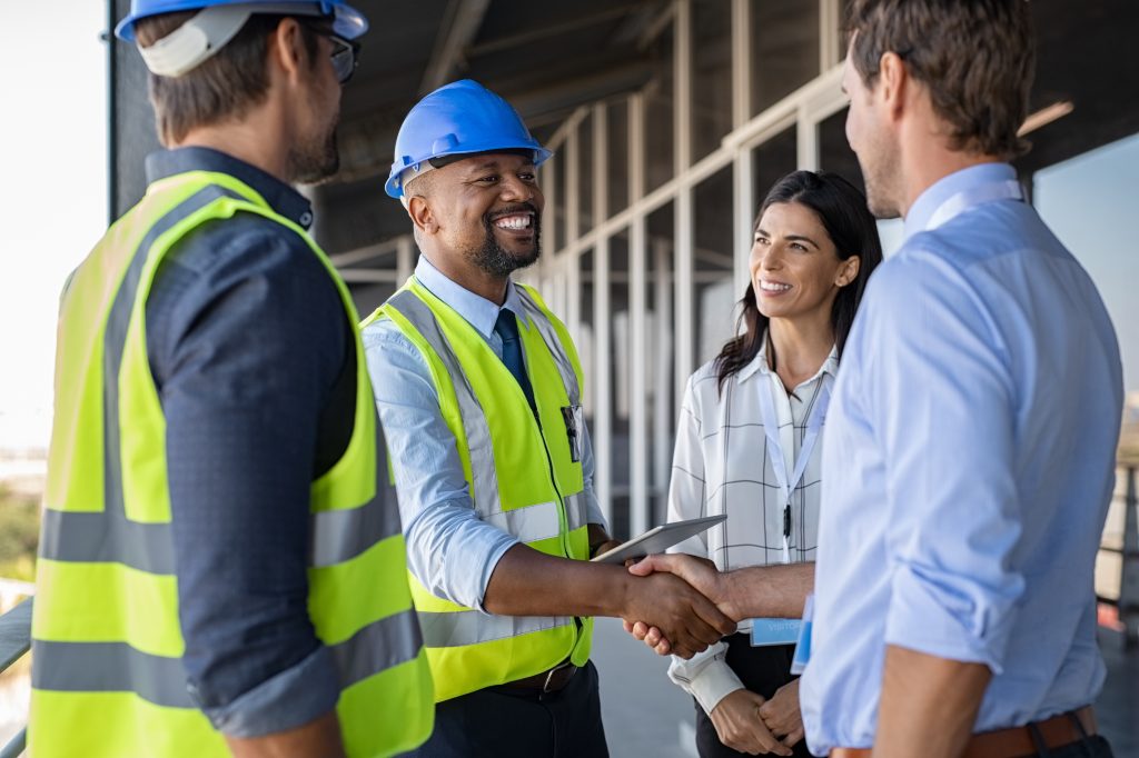Blockchain construction timestamping builders shaking hands.