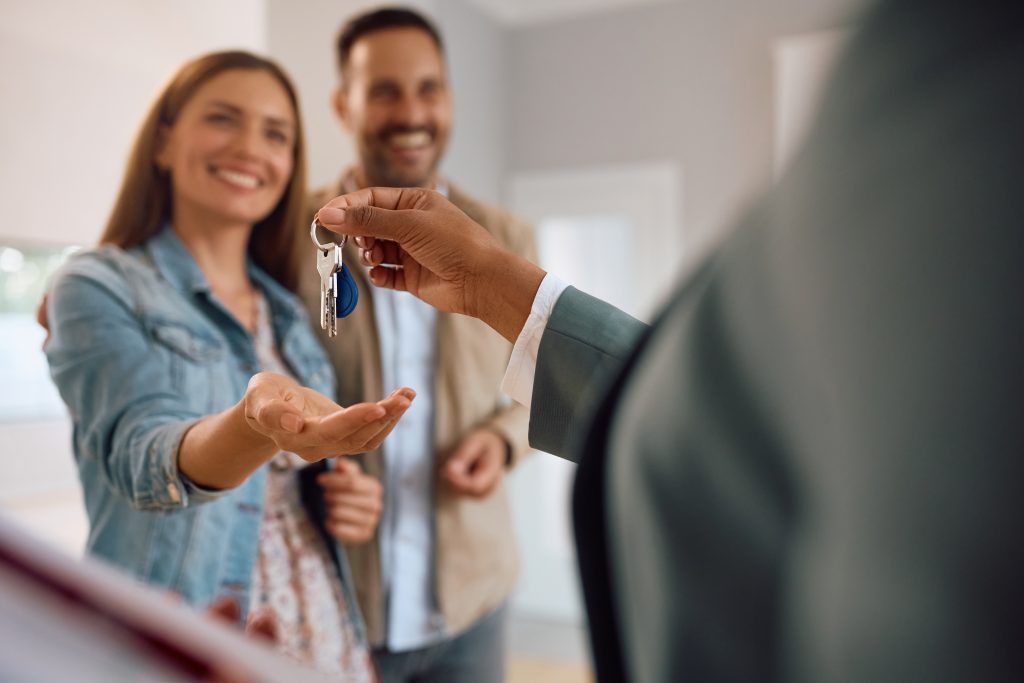 Blockchain property inspection timestamping in action with smiling clients and keys being handed over.