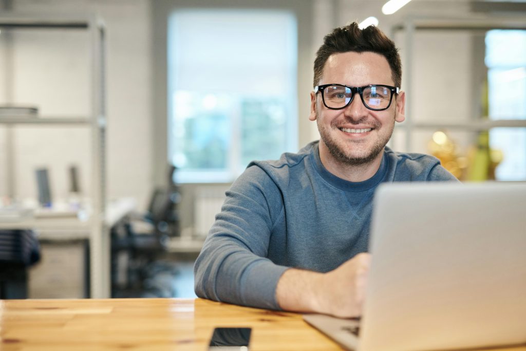Person working on a laptop indoors. Blockchain Timestamp Pricing Plans.