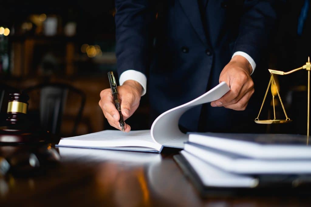 Lawyer writing in legal documents