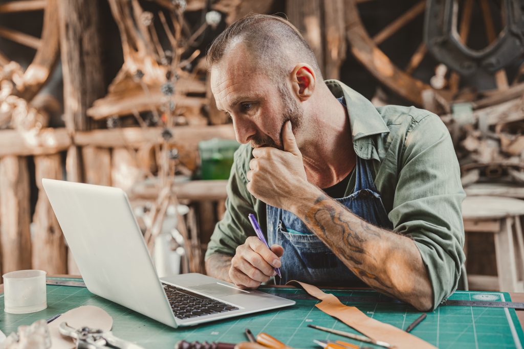 Man working on a laptop creatively. Creative Work Verification with TimeBinder.