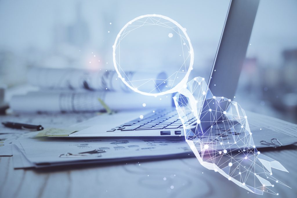 Blockchain research timestamping - magnifying glass looking at laptop.
