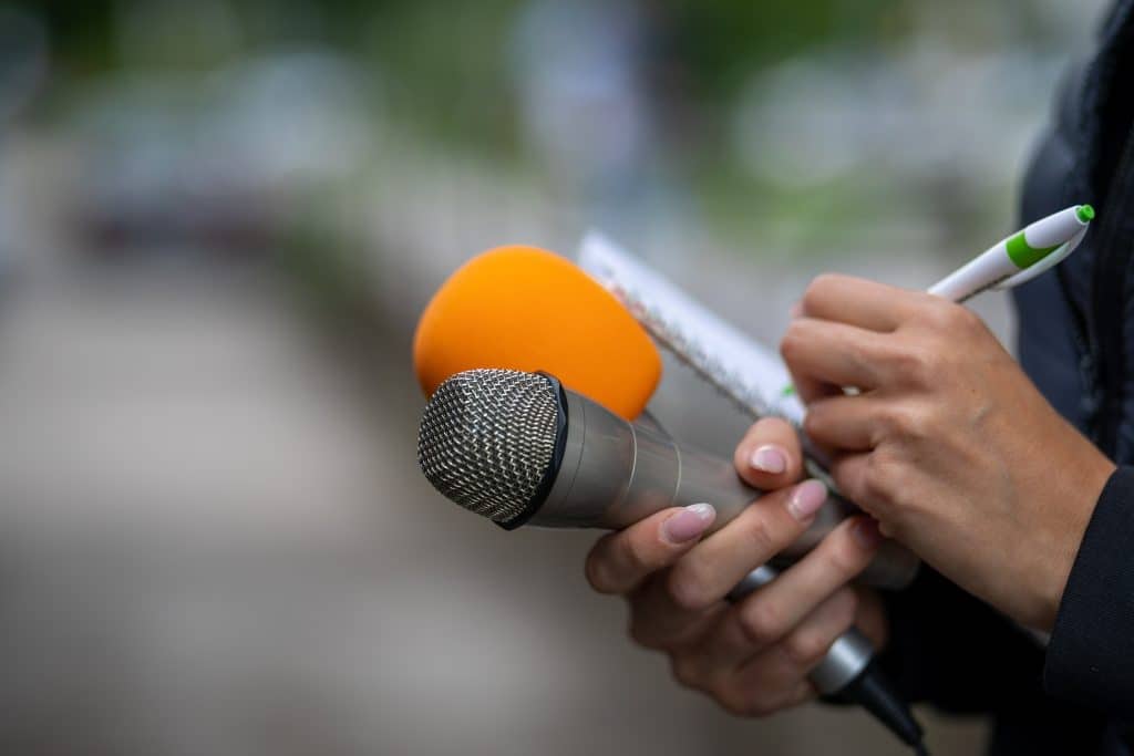 Journalist using blockchain media timestamping protecting article authenticity.